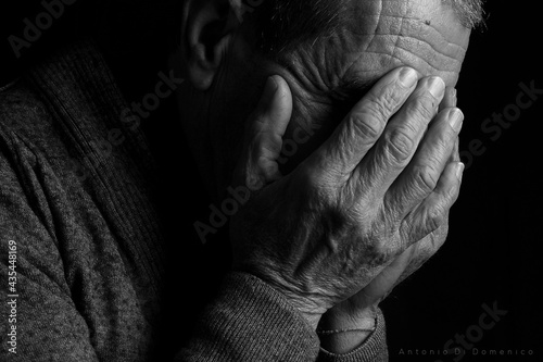 old person with hands on head