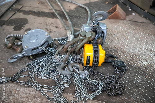 Fotografija crane lift with steel chain and  hooks on the floor