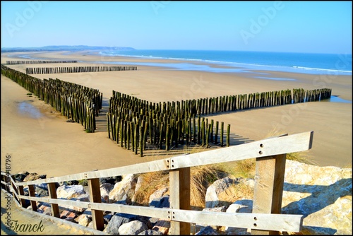 Wooden staircase leading to Rows of breakwater on a beach