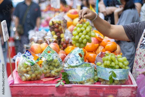 Sticker Buying and selling Fruit at Street food in Chinatown Bangkok Thailand and people
