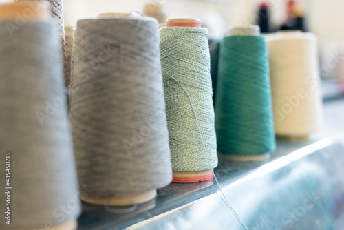 Receding row of cashmere wool on conical spools