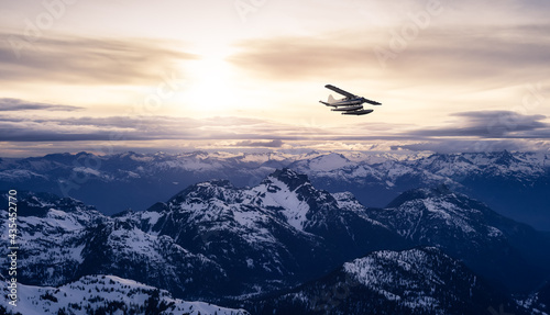 Airplane flying near the Beautiful Canadian Mountain Nature Landscape. Adventure Composite. Dramatic Sunset Sky. Background from near Vancouver, British Columbia, Canada. © edb3_16