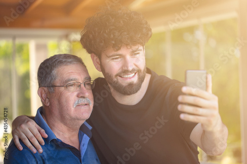 father and son. happy fathers day concept. selfie or video call with phone.