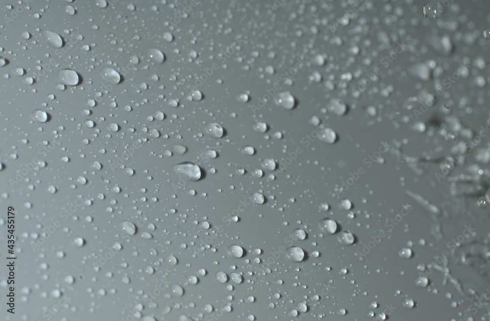 The texture of a water drop on a gray background. Closeup