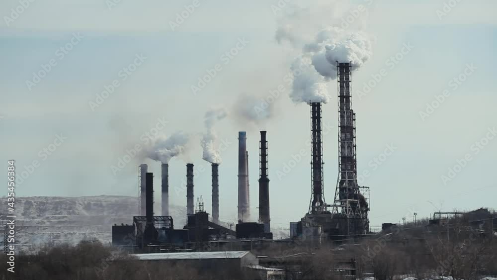 Industrial Complex with Chimneys with White Smoke against A Cloudy Sky. Emissions to the atmosphere. Concept Environmental pollution, Gas Cleaning, Metallurgy, Manufacturing, Industry Industrial Complex with Chimneys with White Smoke against A Cloudy Sky. Emissions to the atmosphere. Concept Environmental pollution, Gas Cleaning, Metallurgy, Manufacturing, Industry