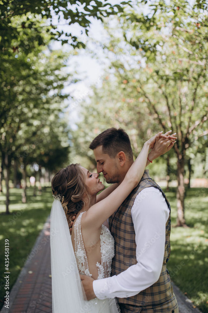 Walking the bride and groom outdoors. Beautiful summer photo session in nature. Walking the bride and groom outdoors. Beautiful summer photo session in nature.