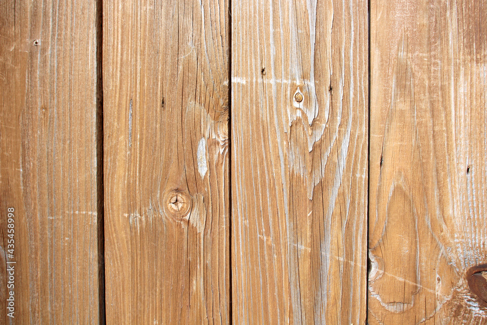 Naklejka premium Light brown wooden board with natural pattern, texture of a wooden wall background..