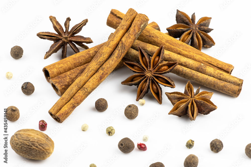 Cinnamon, anise stars, allspice isolated on a white background.