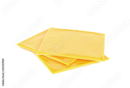 Slices of processed American cheese on white background