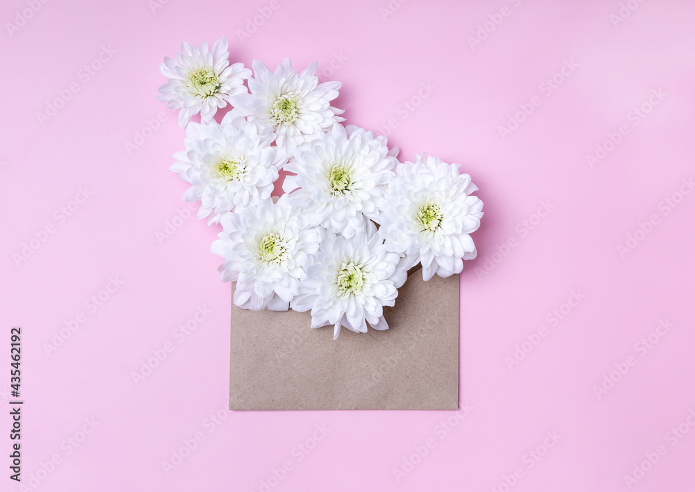 craft envelope with white chrysanthemum flowers. Creative Greeting Card
