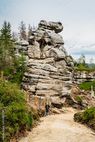 Ostas Nature Reserve and table mountain,Broumov region,Czech republic.Female backpacker in romantic rocky canynon enjoying view of bizarre sandstone formations and freedom of hiking.Labyrinth of rocks photo