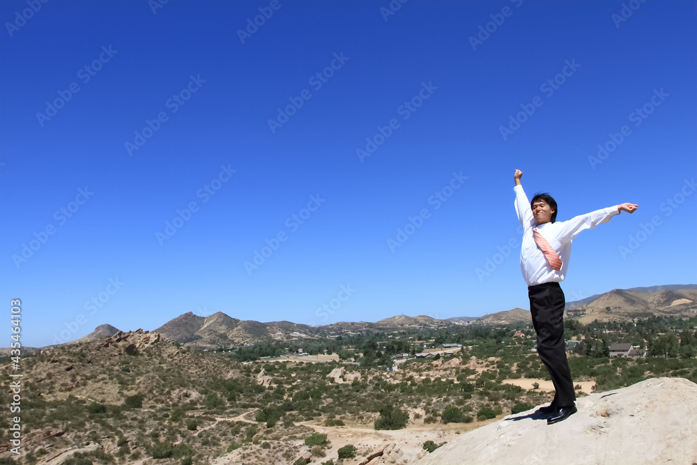 Young businessman stretching in the vast desert Young businessman stretching in the vast desert