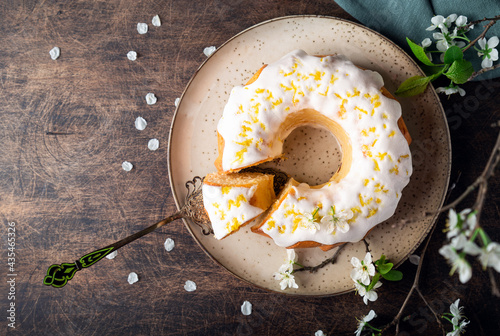 Homemade lemon bundt cake decorated with white glaze and zest