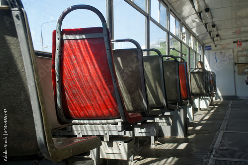Old empty plastic seats inside the tram. Seat heating system