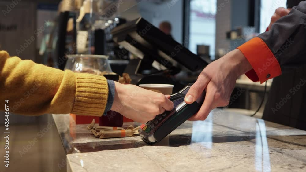 Client pay with credit card on pos terminal at cafe counter Spbi. Wireless purchase and finance