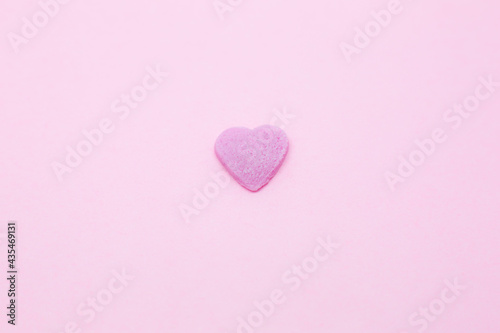 Pink heart on pink background. Saint Valentine's day concept. Love and romantic photo. Postcard for holiday. Beautiful warm wallpaper with love. Soft focus. Copy space.