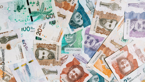 Colombian money of different denominations on white background