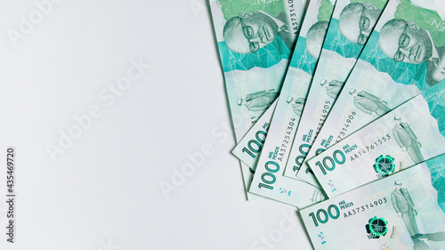 colombian money, one hundred thousand pesos on white background