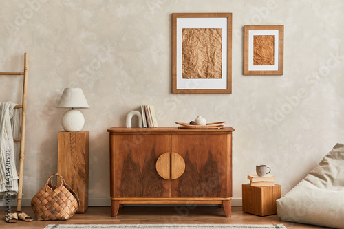 Interior design of neutral living room with stylish retro commode, mock up poster frame, cube, table lamp, decoration and elegant personal accessories in home decor. Template. Japandi concept..