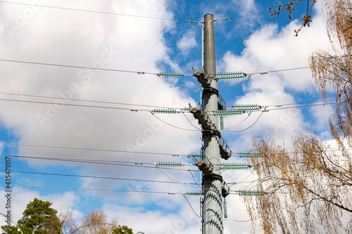 Steel tower of power lines in the background of clouds. Technological concept.