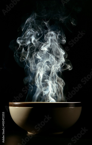Picture of smoke rising from the food above the cup The concept of hot food.