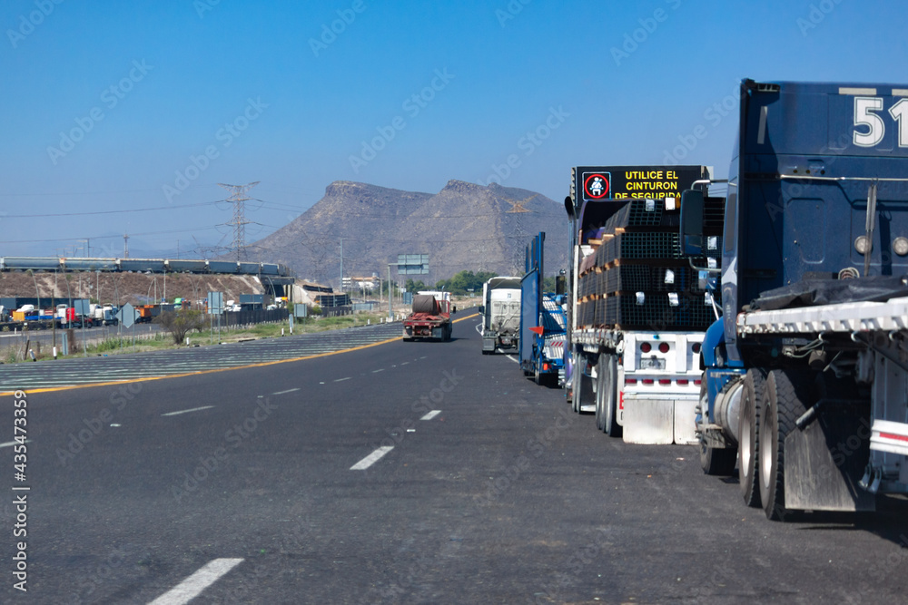 trucks on the highway with mountains