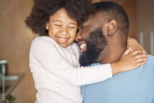 Happy laughing african american father and daughter indoors headshot portrait