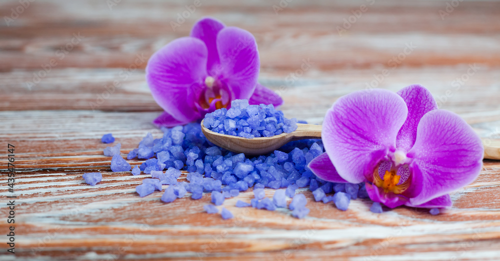 Spa composition with sea salt and orchids on wooden background. Spa treatments. Close-up. Copy space. Spa composition with sea salt and orchids on wooden background. Spa treatments. Close-up. Copy space.