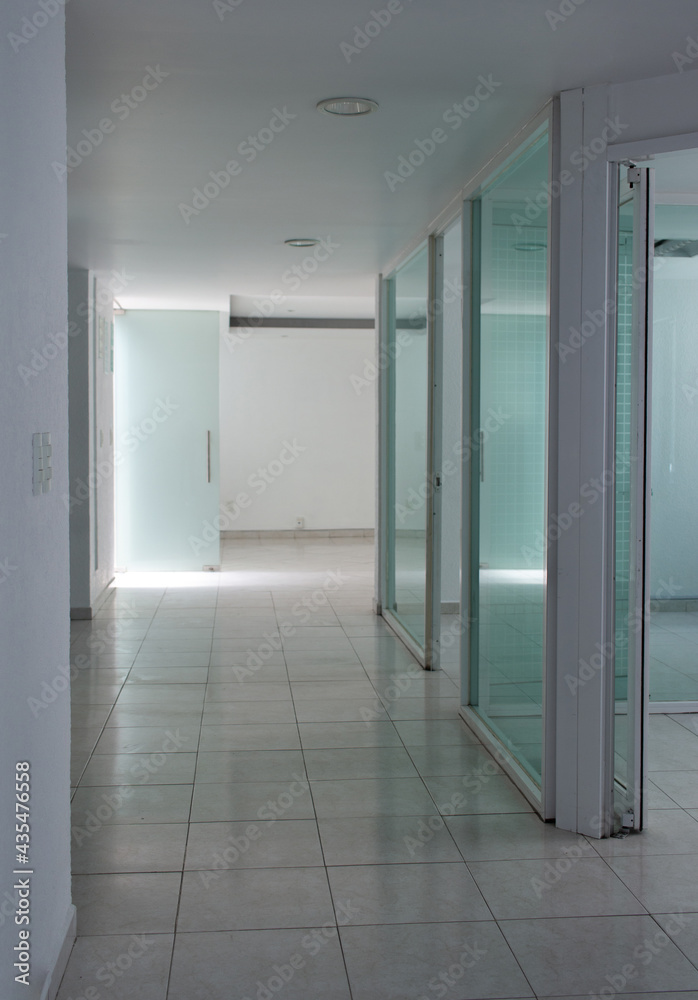 interior of an empty modern office with white concrete and glass doors. Bright empty space interior of an empty modern office with white concrete and glass doors. Bright empty space