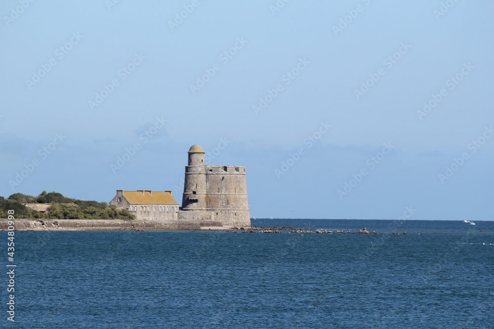a historical vauban tower at the french coast in saint vaast la hougue, normandy, france in summer