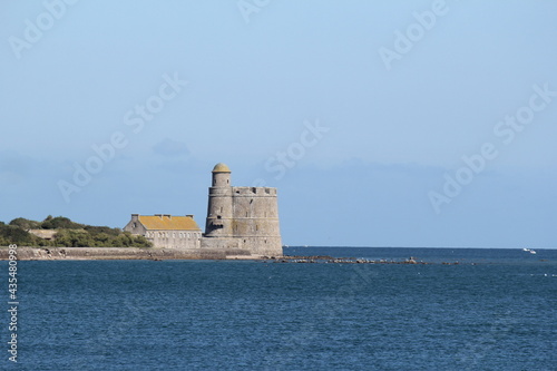 a historical vauban tower at the french coast in saint vaast la hougue, normandy, france in summer