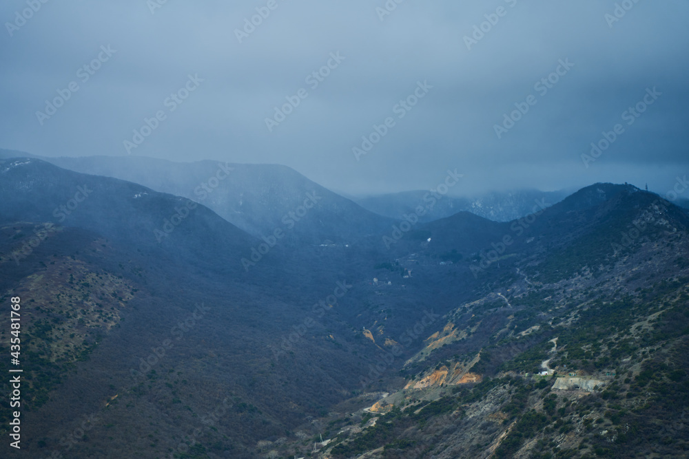 Landscape of mountains with cloudy sky and fog on a cloudy day. Autumn rainy day