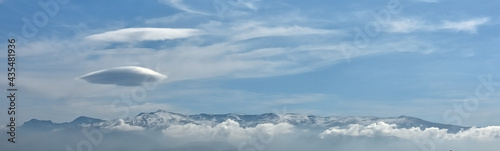 Panoramic view of Sierra Nevada (Spain) between low and other lenticular clouds over Mulhacen, the highest peak in the Iberian Peninsula
