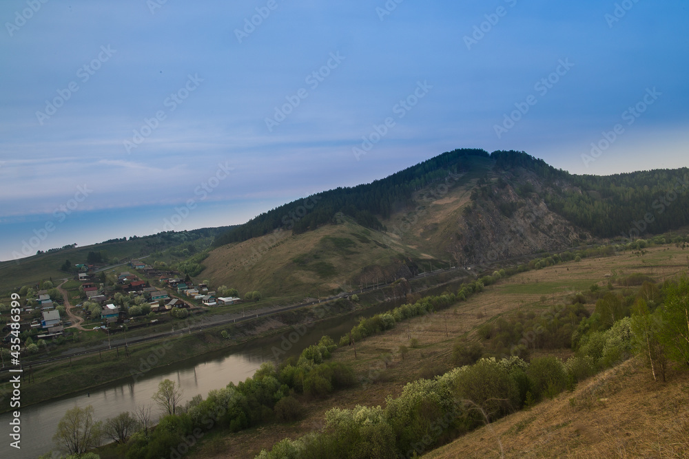 Ural mountain river Yuryuzan flows along rocks and taiga.