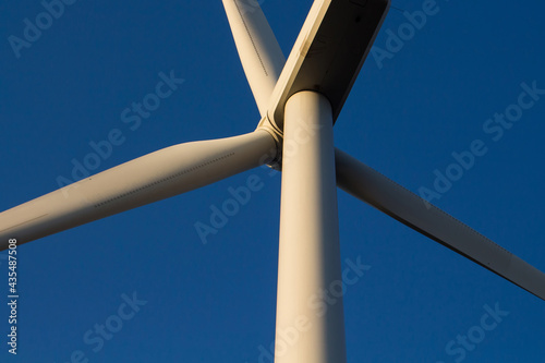 Close up footage of windmill in Sigacik / Seferihisar district of Izmir / Turkey. Wind power turbine for clean, renewable energy. Sustainability concept. It is a sunny summer day.