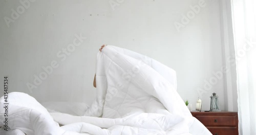 young beautiful Asian woman lying in bed late at night, struggling to sleep, suffers insomnia or fear of nightmares, looks sad, worried about mental health concepts