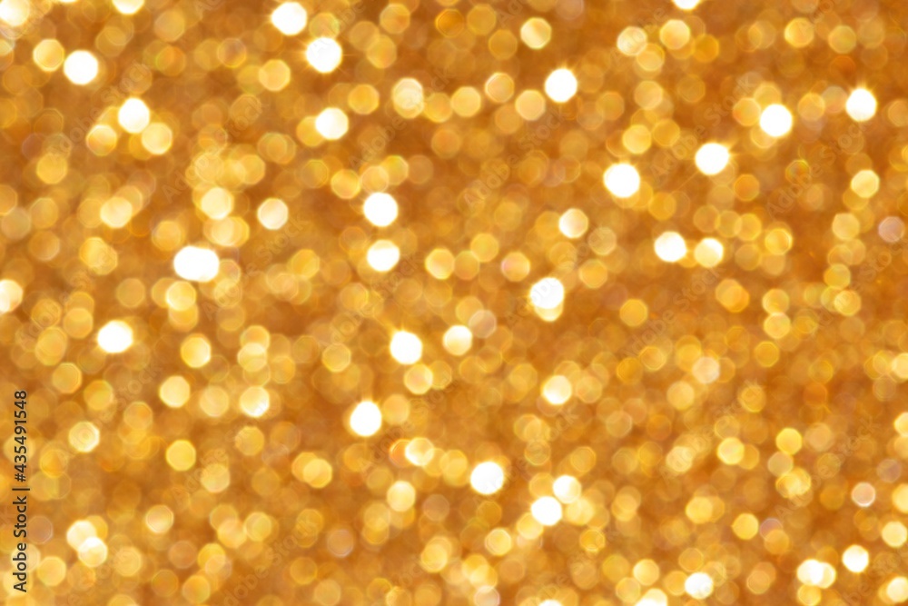 Golden sequin bokeh with a bright glow. Festive mood. Blurred background. Golden sequin bokeh with a bright glow. Festive mood. Blurred background.