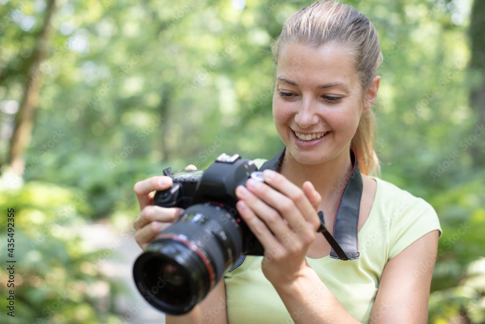 happy female nature photographer at work