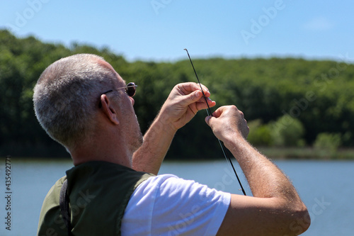A Fisherman Setting Preparing His Fishing Rod Before Start Fishing