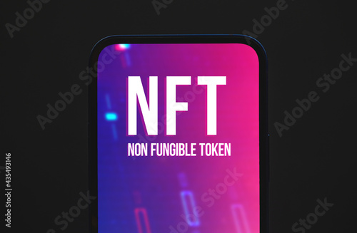 NFT nonfungible tokens concept background, logo on the screen of modern moble phone, top view photo photo