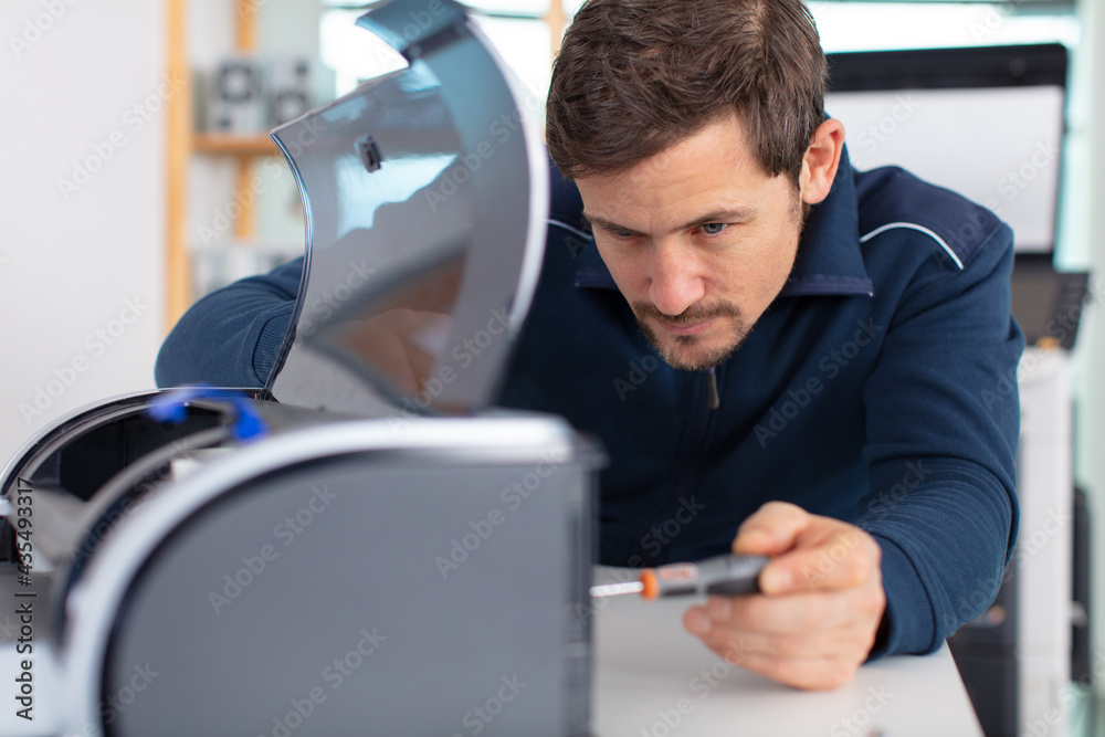 man technician repairing a printer at business place at work man technician repairing a printer at business place at work