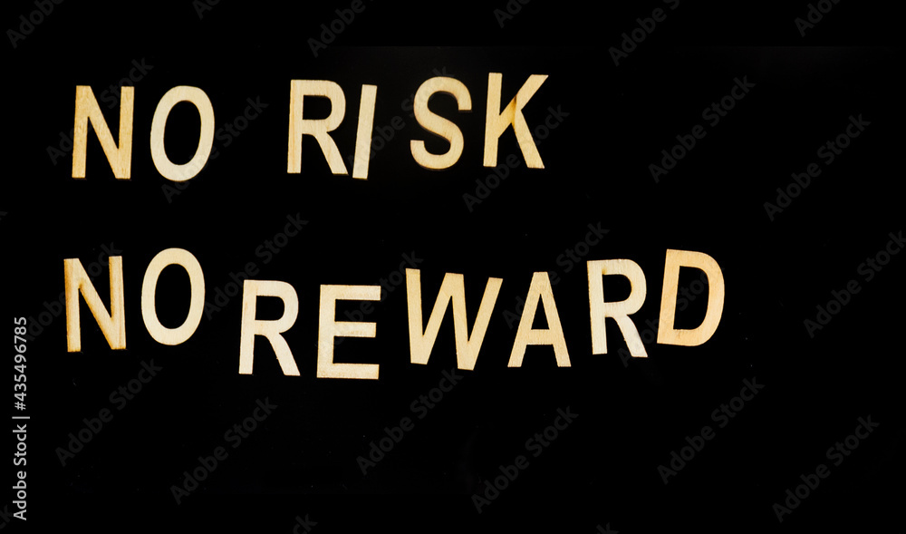 On a black background, wooden letters with the text: No risk, no reward