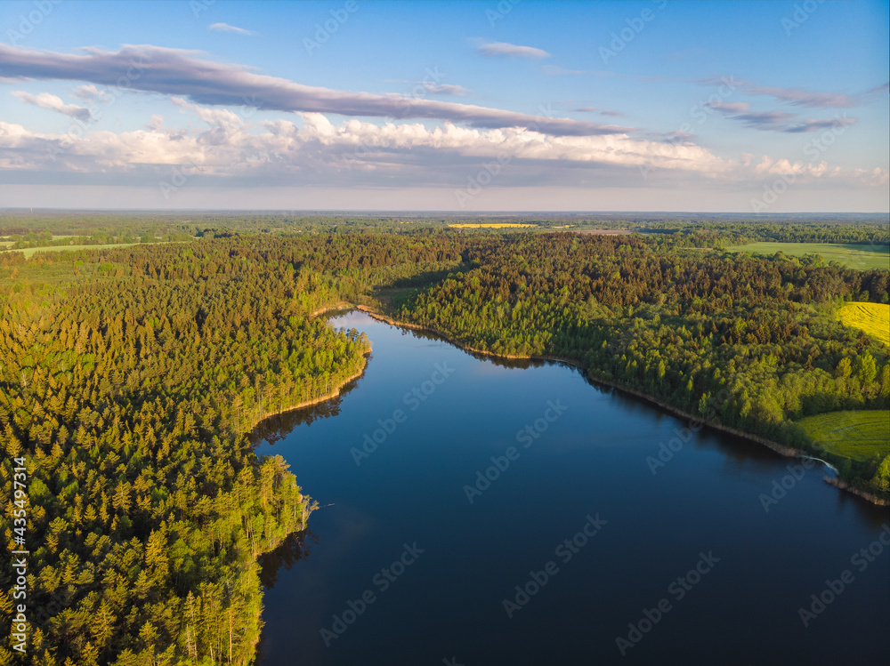The morning sun and reflection in the lake. National park in Belarus. Vitebsk region.