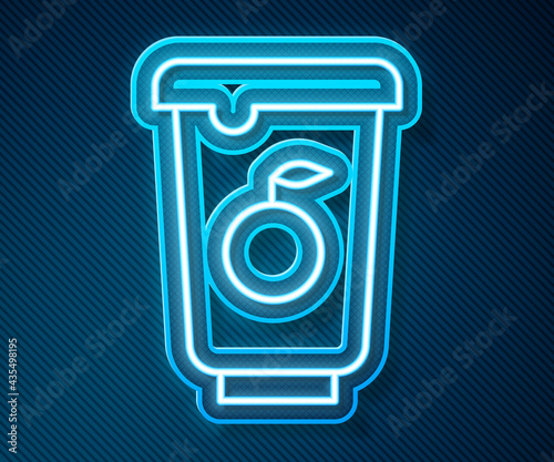 Glowing neon line Yogurt container icon isolated on blue background. Yogurt in plastic cup. Vector