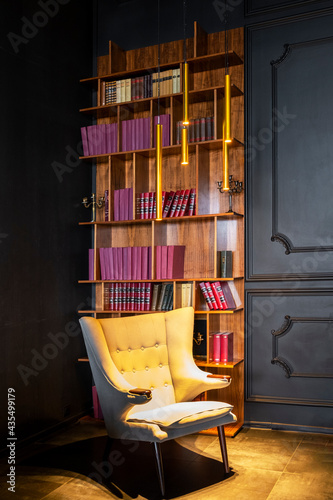 Saint Petersburg, Russia - 07.06.2020: empty white armchair in vintage library with red books