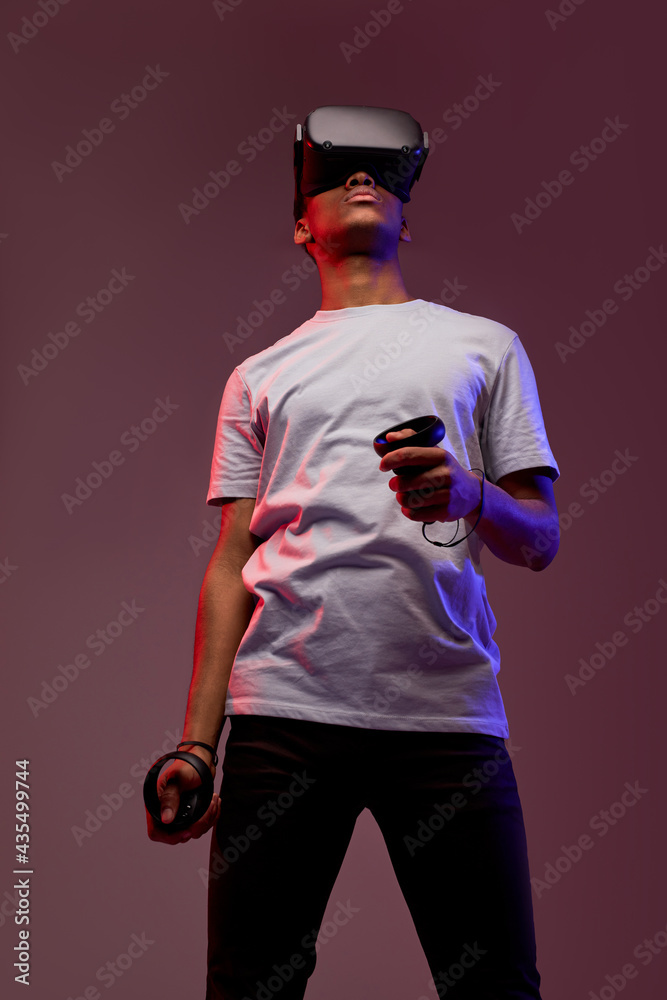 african american guy using vr headset, experiencing virtual reality ...