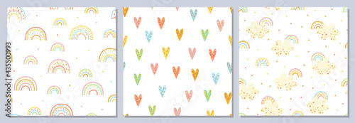 Set of seamless cute patterns. Fun colored cartoon rainbows, hearts, clouds. Sweet dream.