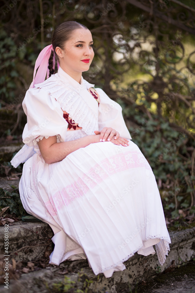 Young beautiful slovak woman in traditional dress. Slovak folklore