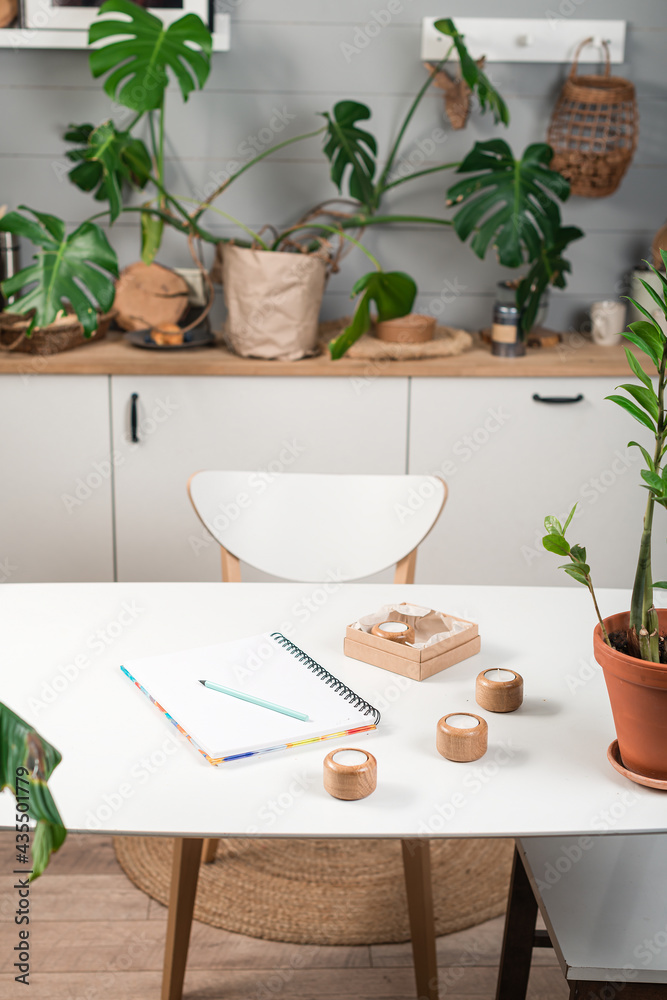 blank opened notebook with cup of coffee and memo note on table. work space with mug of coffee, plat in pot Stylish interior of home office room blank opened notebook with cup of coffee and memo note on table. work space with mug of coffee, plat in pot Stylish interior of home office room