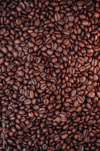 Roasted coffee beans with background. Vertical image